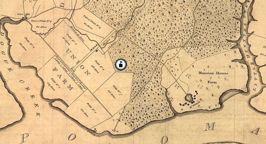 The image shows a portion of George Washington's map of Mount Vernon. The entire estate was approximately 8,000 acres in size and was comprised of five separate farms. Two of these farms, Mansion House Farm and Union Farm, are visible in this image. The map was drawn with iron gall ink on paper or parchment. The ink has faded to a light brown / gray color and the paper has faded to a light tan. An icon of a schoolhouse has been placed on the map, showing Washington Mill Elementary School was located on forested land adjacent to Union Farm. 