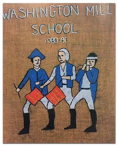 Color photograph of the Colonials mascot printed in our 1997 to 1998 yearbook. It appears to be a needlepoint embroidery on canvas. Embroidered text reads: Washington Mill School, 1980 to 81, Mr. Ringman, 5th Grade. The mascot is three men wearing blue and white American Revolutionary War era uniforms with black boots. Two of the men are beating red drums and a third is playing a flute. One of the men is wearing a blue tri-cornered hat. These colorful figures have been stitched onto a brown canvas backing.   