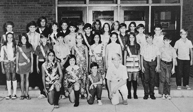 Black and white yearbook photograph of Washington Mill's Safety Patrol. 30 students are pictured, an even mix of boys and girls. Each child is wearing a distinctive sash and belt, very similar to the ones worn by students today.   